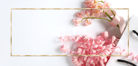 Pink spring flowers, pink gift streamer in white gift bag on white background. Beautiful spring card for Birthday, Woman, Valentines, Mothers Day in pastel colours. Horizontal flat lay. Copy spaceの写真素材