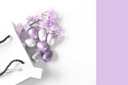 White gift box with spring pink lilac flowers on white background. Flat lay, top view. Concept of trendy digital lavender color. Place for textの写真素材