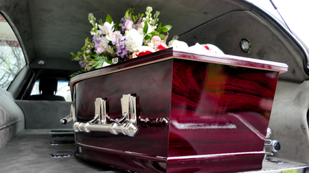 closeup shot of a colorful casket in a hearse or chapel before funeralの写真素材