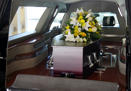 closeup shot of a colorful casket in a hearse or chapel before funeral