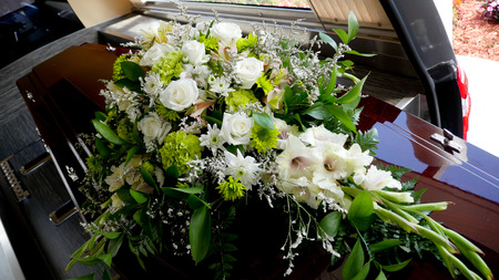 closeup shot of a colorful casket in a hearse or chapel before funeral or burial at cemeteryの写真素材
