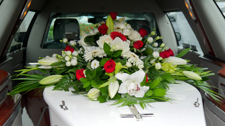 closeup shot of a colorful casket in a hearse or chapel before funeral or burial at cemetery
