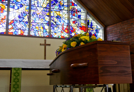 closeup shot of a colorful casket in a hearse or chapel before funeral or burial at cemeteryのeditorial素材