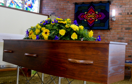 closeup shot of a colorful casket in a hearse or chapel before funeral or burial at cemeteryのeditorial素材