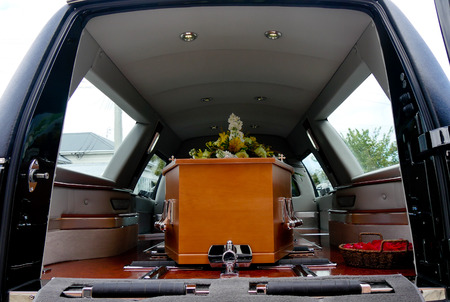 closeup shot of a colorful casket in a hearse or chapel before funeral or burial at cemeteryの写真素材