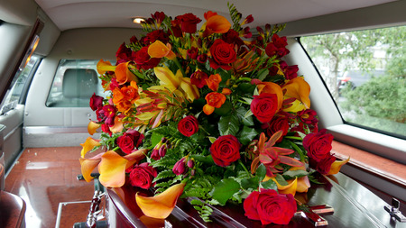 closeup shot of a colorful casket in a hearse or chapel before funeral or burial at cemetery