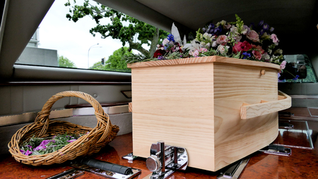 closeup shot of a colorful casket in a hearse or chapel before funeral or burial at cemeteryの写真素材