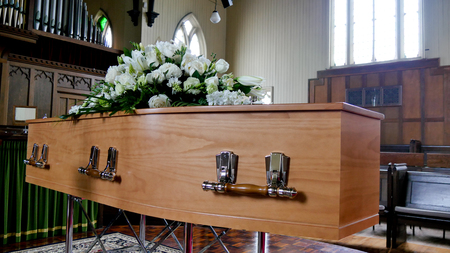 closeup shot of a colorful casket in a hearse or chapel before funeral or burial at cemeteryのeditorial素材
