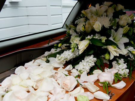 closeup shot of a colorful casket in a hearse or chapel before funeral or burial at cemeteryの写真素材