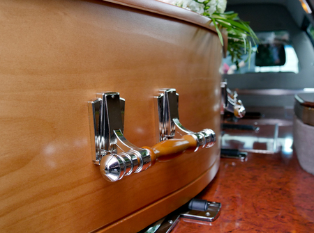 closeup shot of a colorful casket in a hearse or chapel before funeral or burial at cemeteryの写真素材