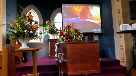 closeup shot of a colorful casket in a hearse or chapel before funeral or burial at cemeteryのeditorial素材