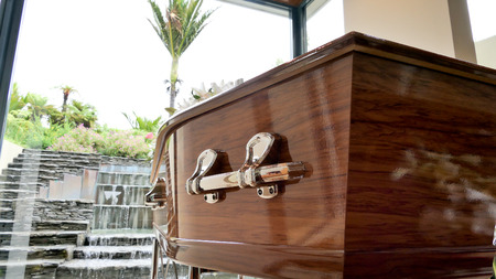 closeup shot of a colorful casket in a hearse or chapel before funeral or burial at cemeteryの写真素材