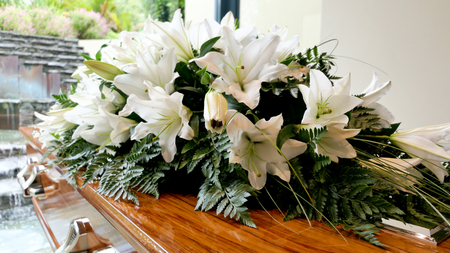 closeup shot of a colorful casket in a hearse or chapel before funeral or burial at cemeteryの写真素材