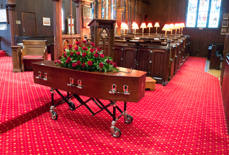 closeup shot of a colorful casket in a hearse or chapel before funeral or burial at cemeteryのeditorial素材
