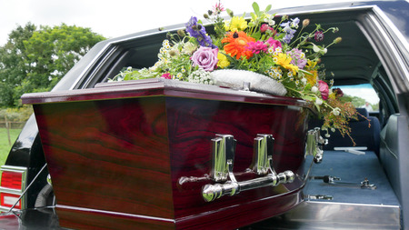 closeup shot of a colorful casket in a hearse or chapel before funeral or burial at cemeteryの写真素材