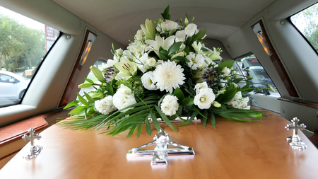closeup shot of a colorful casket in a hearse or chapel before funeral or burial at cemetery