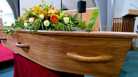 closeup shot of a colorful casket in a hearse or chapel before funeral or burial at cemeteryの写真素材