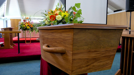 closeup shot of a colorful casket in a hearse or chapel before funeral or burial at cemeteryの写真素材