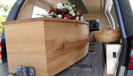 closeup shot of a colorful casket in a hearse or chapel before funeral or burial at cemeteryの写真素材