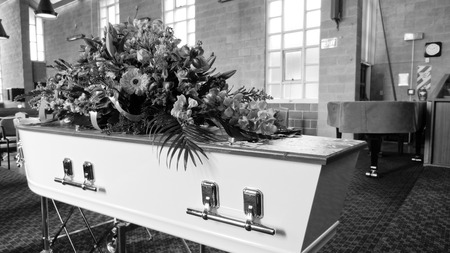 closeup shot of a funeral casket in a hearse or chapel or burial at cemeteryのeditorial素材