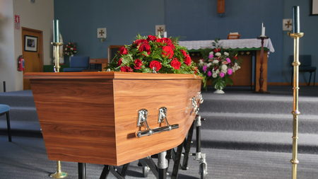 closeup shot of a funeral casket in a hearse or chapel or burial at cemeteryのeditorial素材