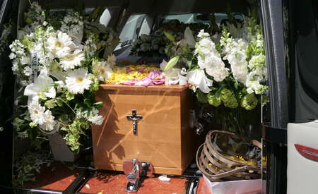 closeup shot of a funeral casket in a hearse or chapel or burial at cemeteryの写真素材
