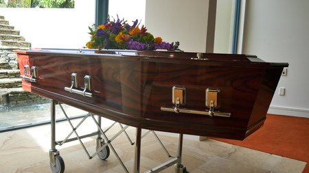 closeup shot of a funeral casket in a hearse or chapel or burial at cemeteryの写真素材