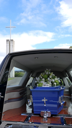 closeup shot of a funeral casket in a hearse or chapel or burial at cemeteryの写真素材