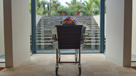 closeup shot of a funeral casket in a hearse or chapel or burial at cemeteryの写真素材