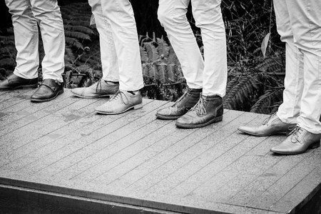 shot of wedding suits, tie, socks, shoes & watches for the groom & groom men
