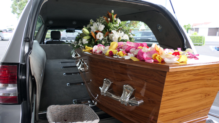 closeup shot of a funeral casket in a hearse or chapel or burial at cemeteryの写真素材