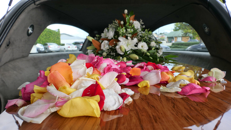closeup shot of a funeral casket in a hearse or chapel or burial at cemeteryの写真素材