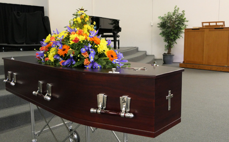 closeup shot of a funeral casket in a hearse or chapel or burial at cemeteryの写真素材