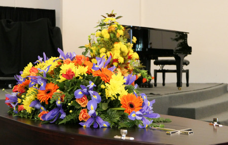 closeup shot of a funeral casket in a hearse or chapel or burial at cemetery