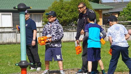 Auckland, New Zealand, 10th of Nov 2019, adults and kids playing nerf gun together at an outdoor...