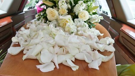 closeup shot of a funeral casket in a hearse or chapel or burial at cemetery