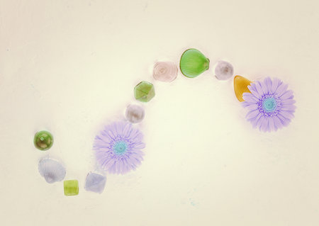 Colorful glass beads and flowers on white background, retro toned