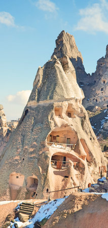 Goreme valley with ancient cave chapels houses city carved into mountain hillside, Cappadocia, Turkeyの写真素材