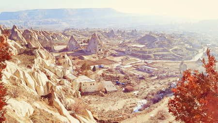 Goreme valley with ancient cave chapels houses city carved into mountain hillside, Cappadocia, Turkeyの写真素材