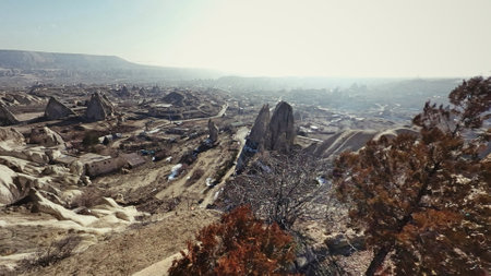 Goreme valley with ancient cave chapels houses city carved into mountain hillside, Cappadocia, Turkeyの写真素材