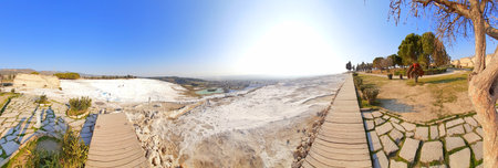 Panoramic view of the white lime cascades travertine pools terraces formed by hot mineral springs at Pamukkale, Turkeyの写真素材