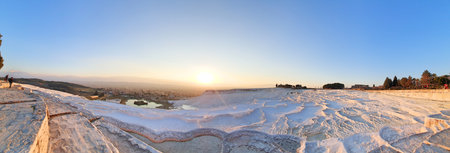 Panoramic view of the white lime cascades travertine pools terraces formed by hot mineral springs at Pamukkale, Turkeyの写真素材