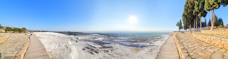 Panoramic view of the white lime cascades travertine pools terraces formed by hot mineral springs at Pamukkale, Turkeyの写真素材
