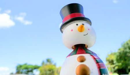 Snowman toy on blue sky background. Christmas and New Year concept.