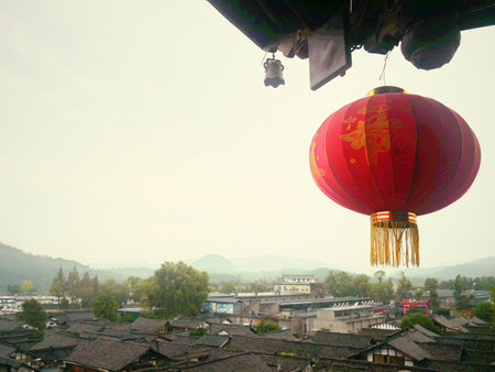 Traditional Chinese Red lantern hanging from the ceiling with old city as backgroundの写真素材