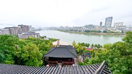A contrast view of the modern city cross the river from an ancient historical templeの写真素材