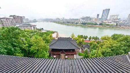 A contrast view of the modern city cross the river from an ancient historical templeの写真素材