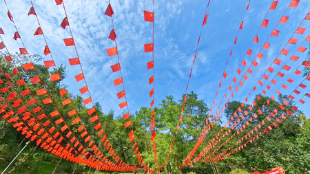 rows of mini China national flags flying in the skyの写真素材