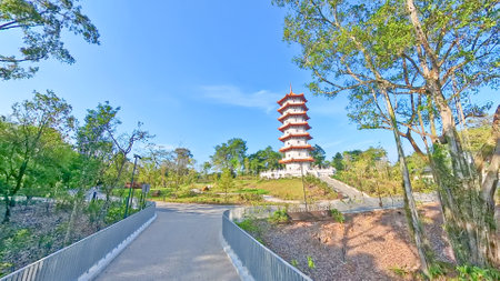 Singapore Chinese Garden. Traditional Chinese pavilions with red roofs and white railings stand over a lake under a bright blue sky.の写真素材