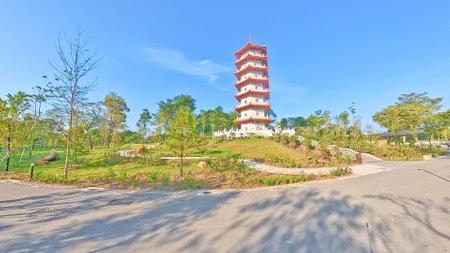 Singapore Chinese Garden. Traditional Chinese pavilions with red roofs and white railings stand over a lake under a bright blue sky.の写真素材